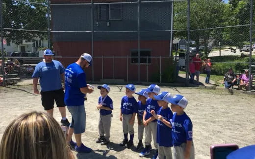 a group of kids playing baseball