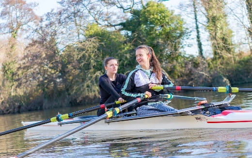 a group of people rowing a boat