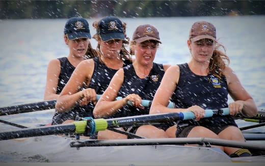 a group of women rowing a boat