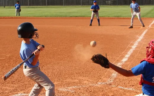 a baseball player hitting a ball with a bat