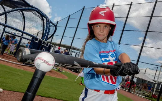 a girl swinging a baseball bat