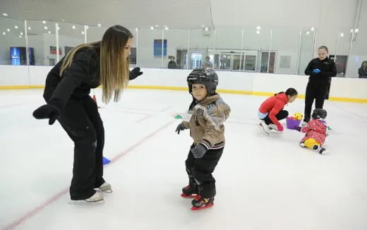 a person and a child on an ice rink