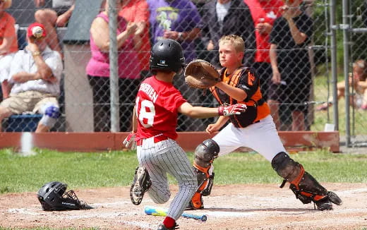 kids playing baseball on a field