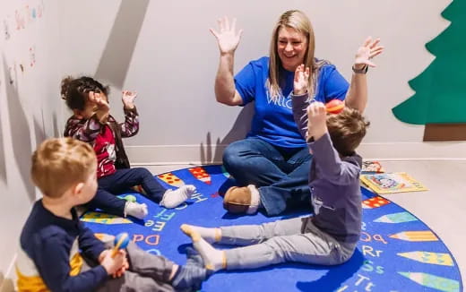 a person and several children sitting on the floor