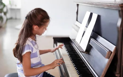 a girl playing a piano