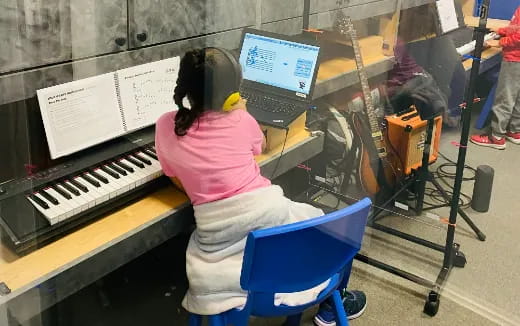 a person sitting at a piano