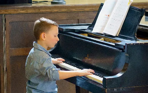 a baby playing a piano