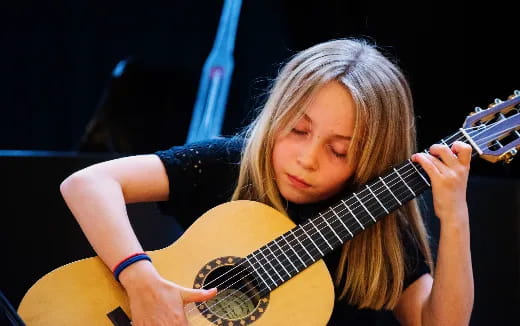 a girl playing a guitar