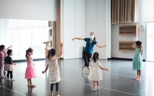 a group of children dancing in a room