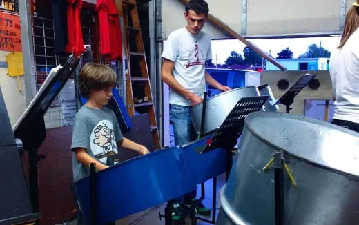 a person and a boy working on a machine