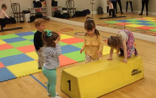 children playing on a yellow mat