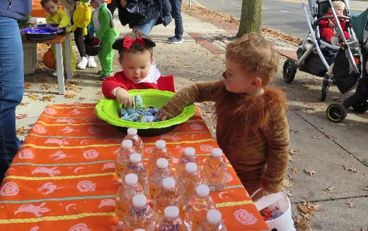 a couple of kids eating at a picnic table