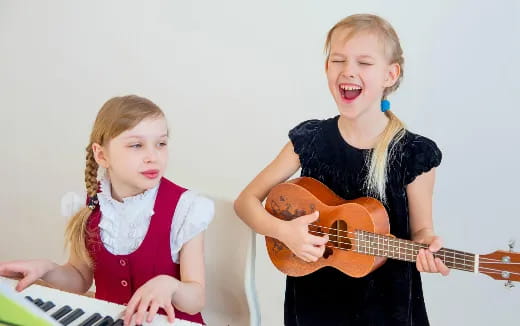 a couple of girls playing musical instruments