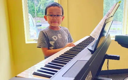 a boy playing a piano