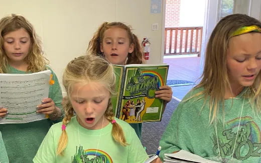 a group of girls holding books