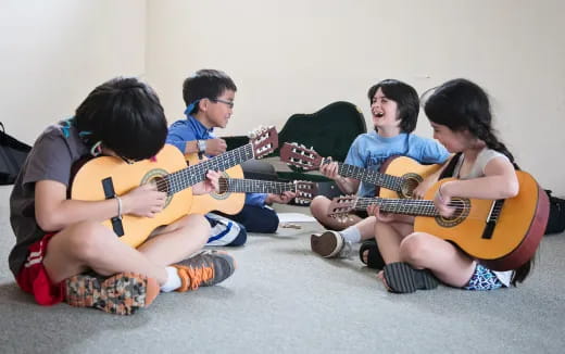 a group of people playing guitars