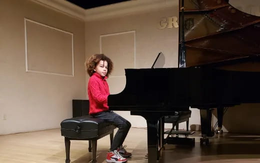 a girl playing a piano