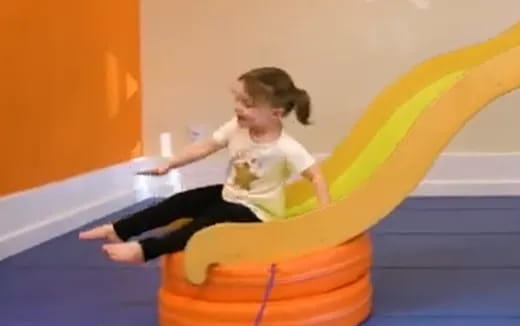 a person sitting on a slide