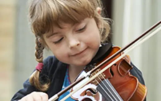 a young girl playing a violin