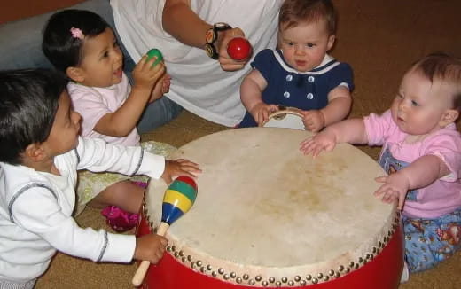 a group of children playing with a cake