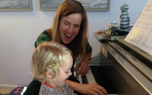 a person and a child playing piano