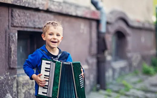 a boy playing an accordion