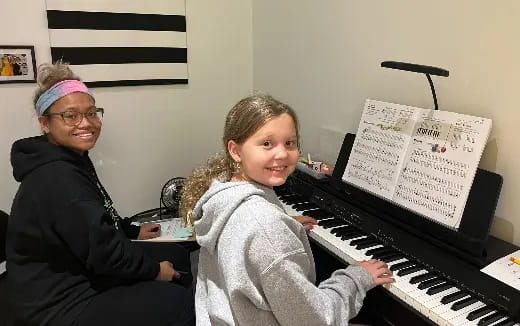 a person and a child playing piano