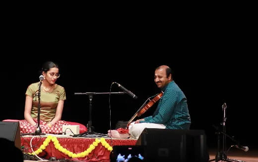 a man and woman playing instruments