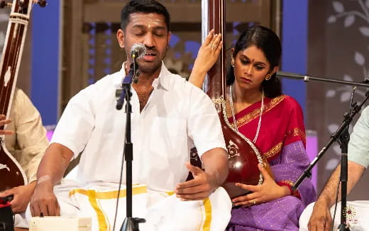 a man and woman singing into microphones