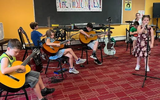 a group of kids playing instruments