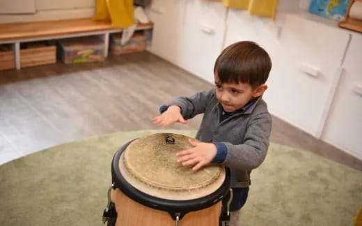 a boy playing a drum