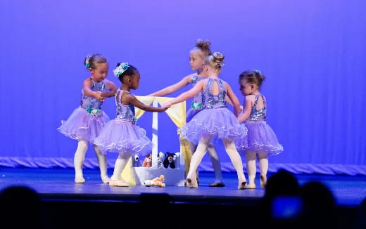 a group of girls performing on a stage