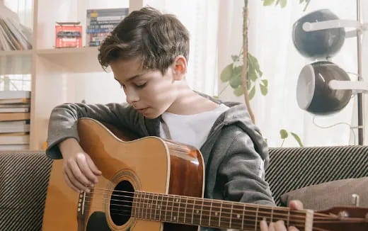 a boy playing a guitar