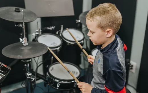 a boy playing drums