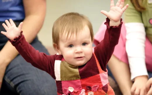 a baby being held by people