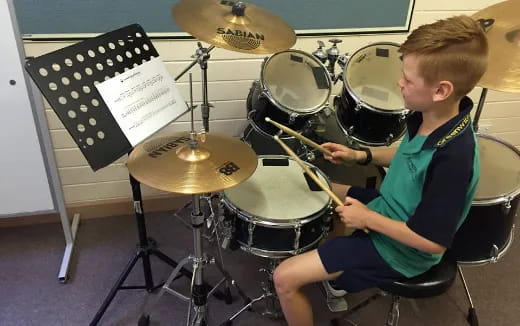 a boy playing the drums