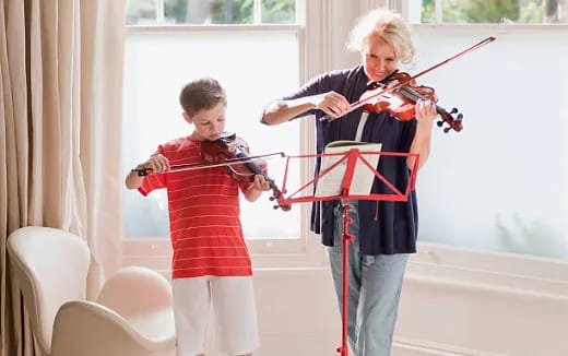 a person and a boy playing violin