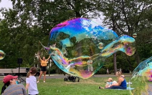 a group of people playing in a large bubble shape