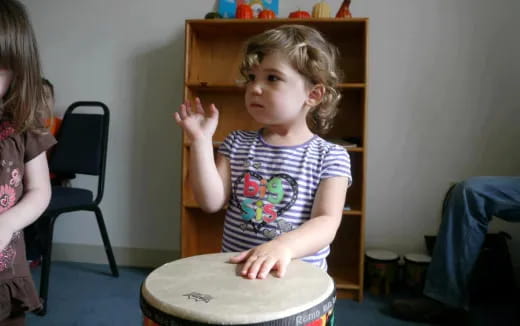 a little girl playing drums