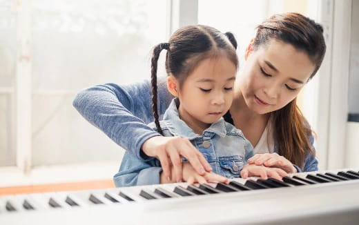 a person and a child looking at a computer screen