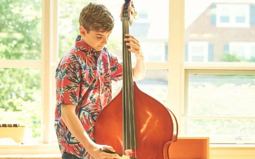 a boy playing a cello