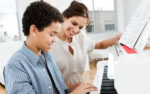 a few young men looking at a computer screen