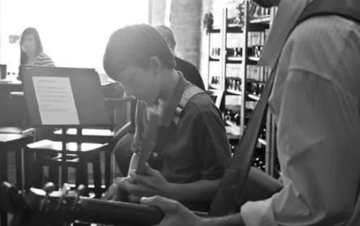 a young boy sitting in a classroom