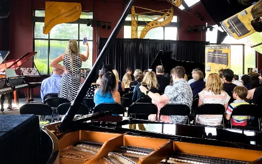 a group of people sitting in a room with instruments