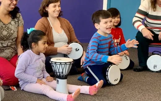 a person and kids playing drums