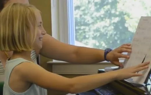 a woman writing on a piece of paper