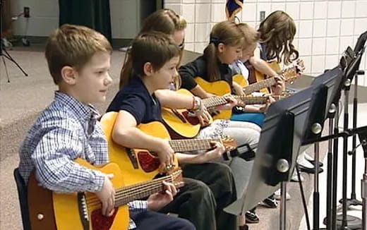 a group of kids playing instruments