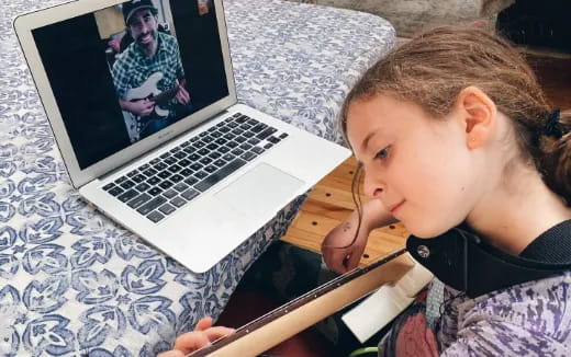 a young boy using a laptop