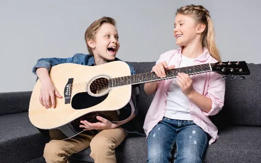 a person and a girl playing a guitar