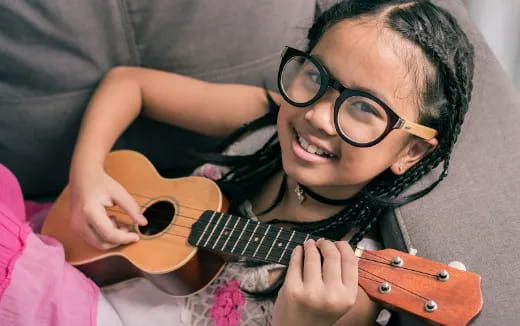 a girl playing a guitar